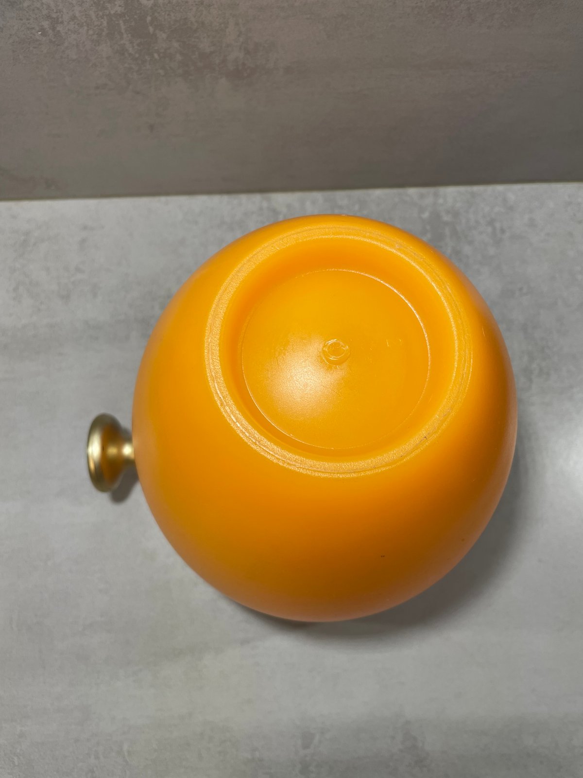 Detail of the translucent orange body and anchor emblem on the Veuve Clicquot champagne bucket