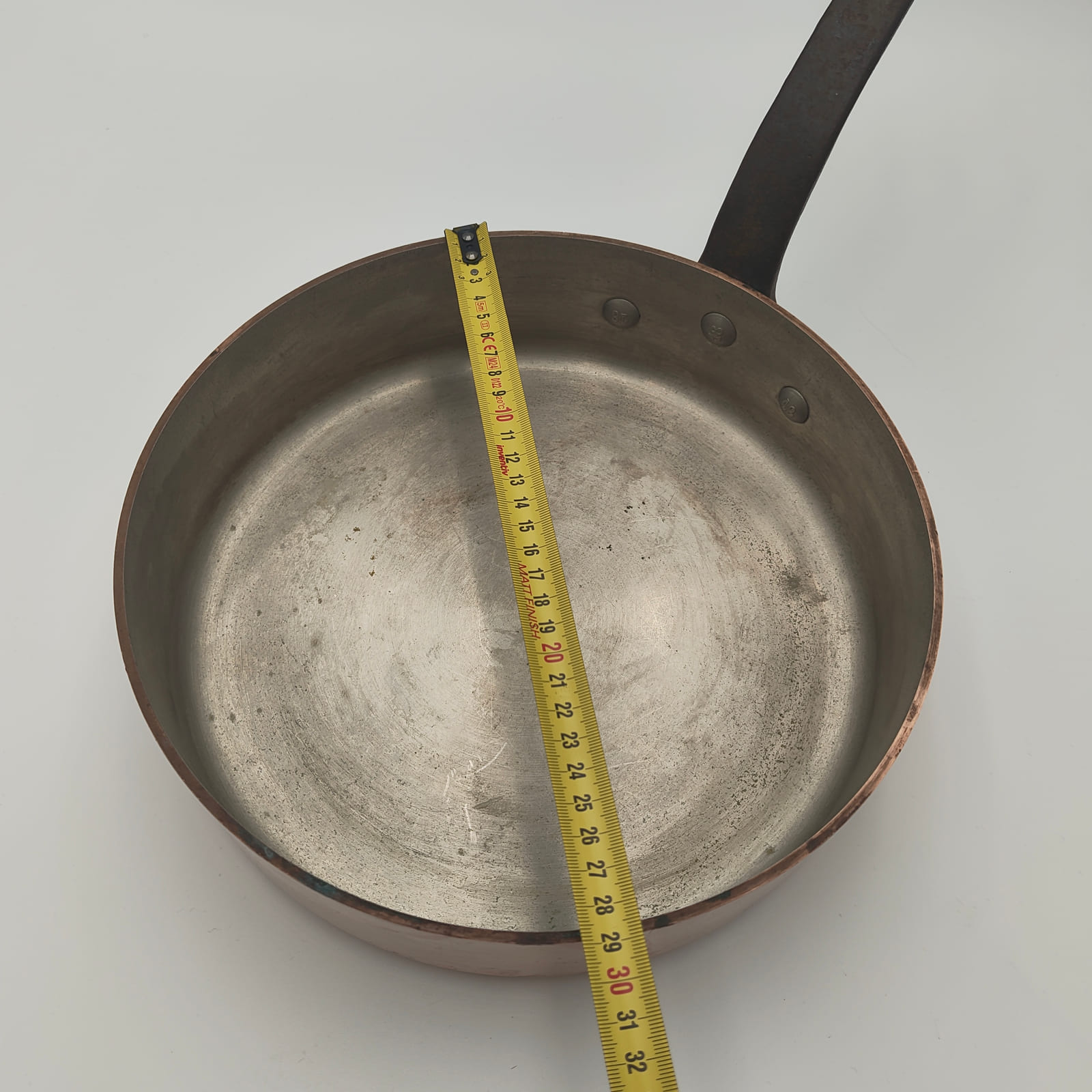 Measuring the approximately 29 cm diameter of an E. Dehillerin copper sauté pan