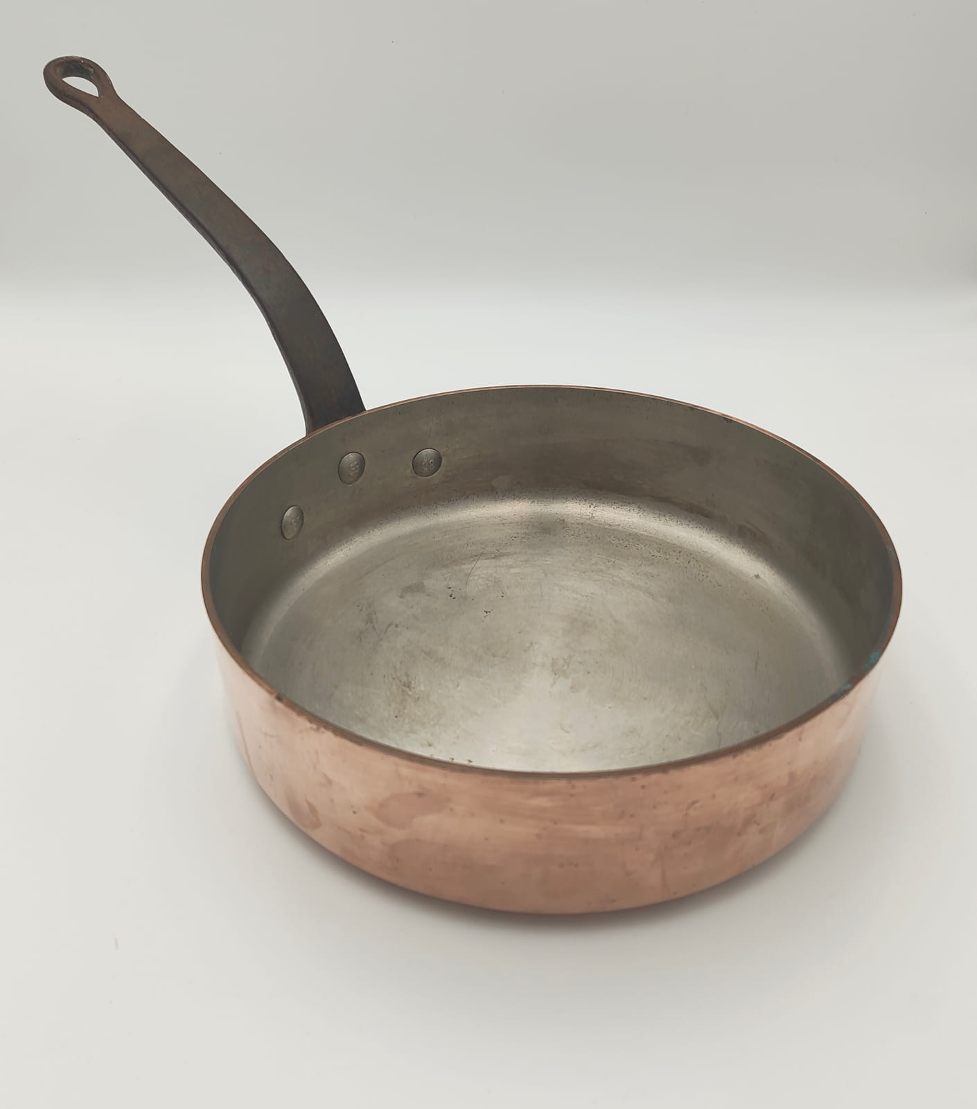 Worn tinned interior of a 29 cm E. Dehillerin copper sauté pan
