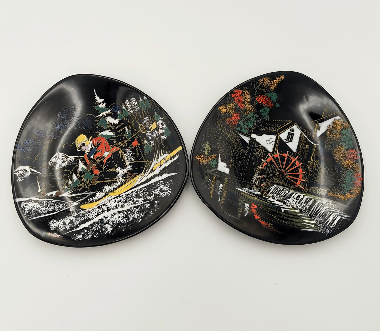 Pair of hand-painted Longwy French decorative ceramic pieces with black ground