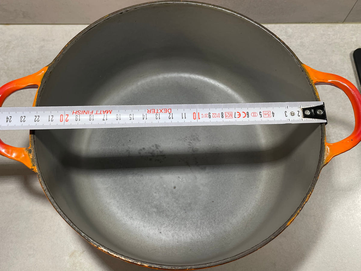 Tape measure laid across the rim of an early Le Creuset round cocotte