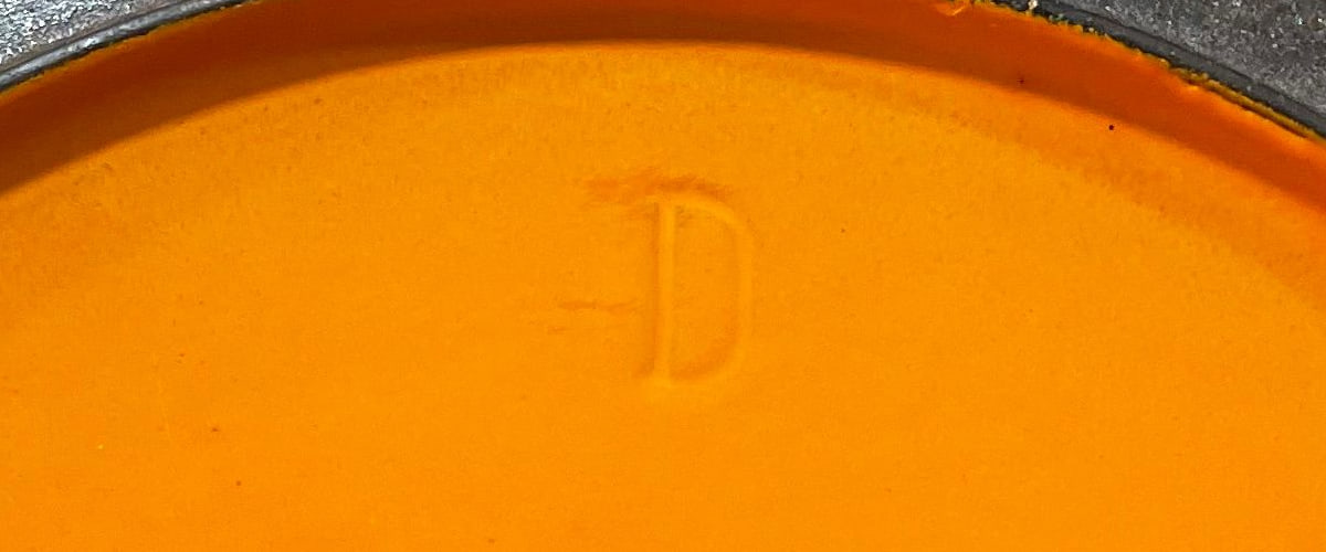 Underside of early Le Creuset cocotte lid with casting mark
