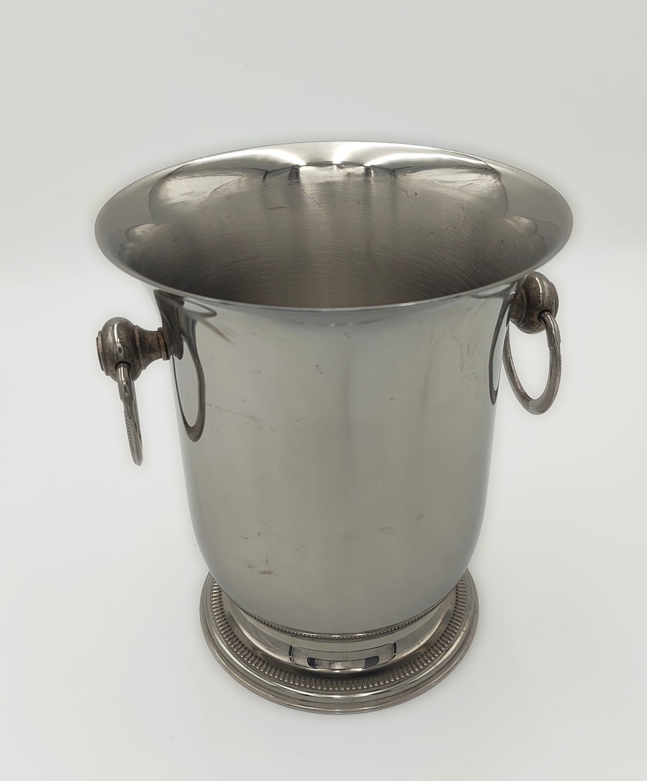 Jean Couzon Orfèvre champagne cooler in polished stainless steel with articulated ring handles and pedestal foot